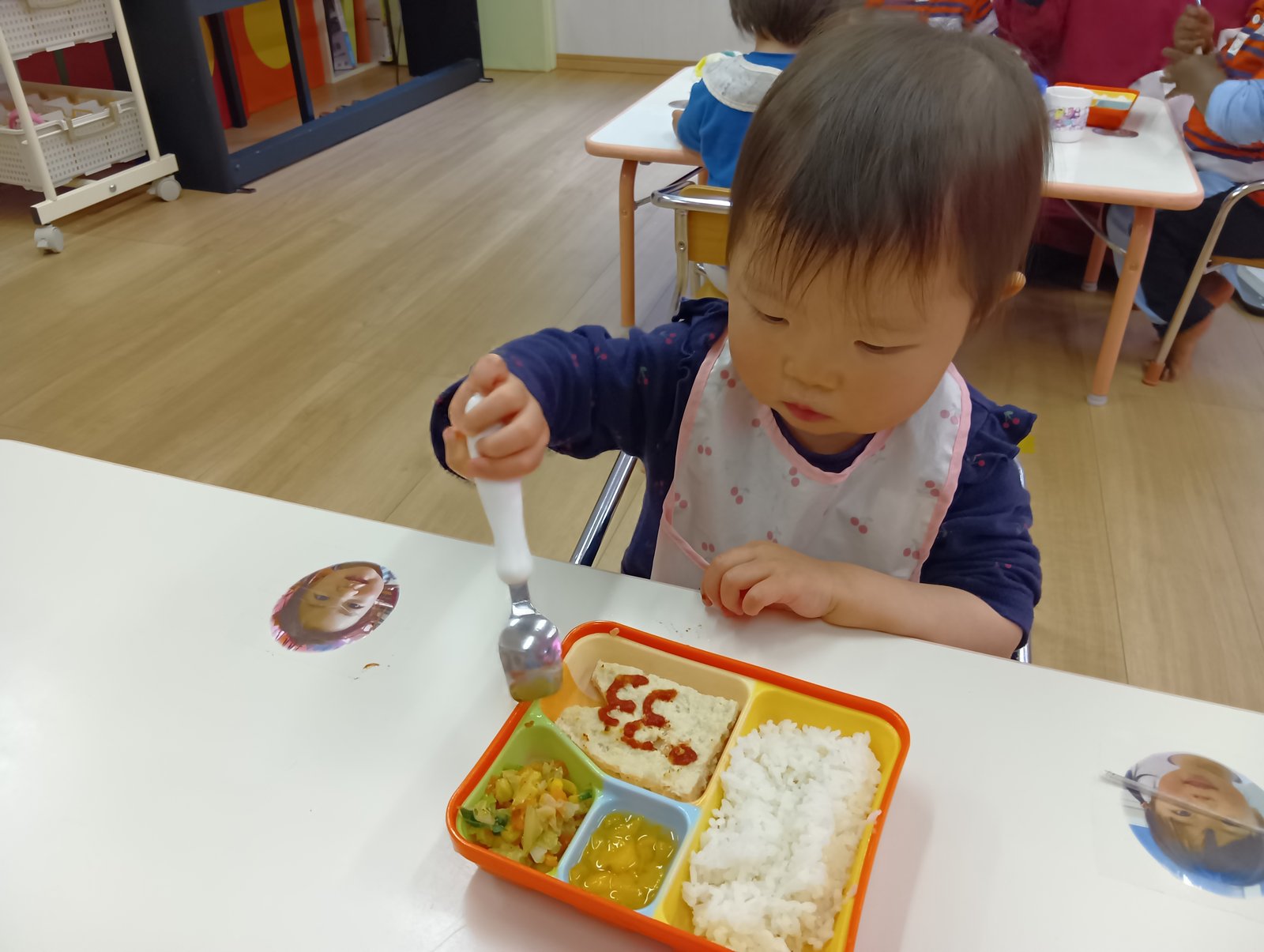 自園調理の給食をスプーンで食べる子ども